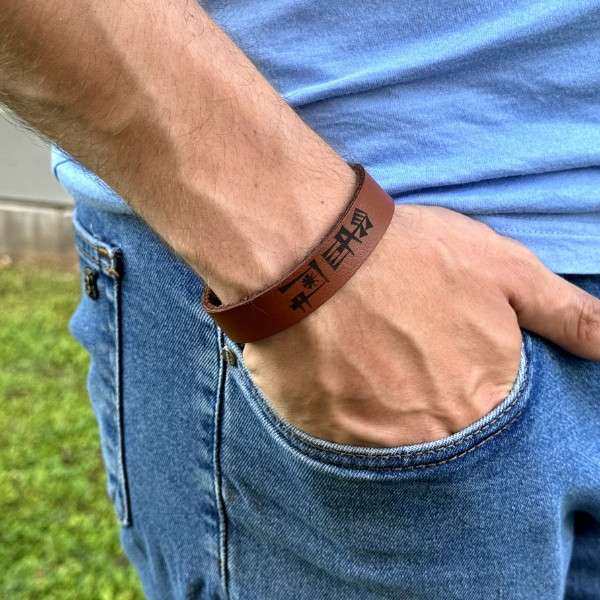 A Natural Leather Bracelet, Handmade and Engraved with The Word Freedom in Cuneiform Characters